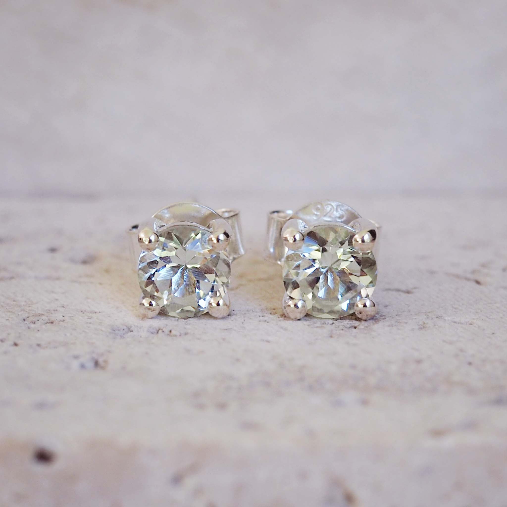Pair of diamond stud earrings on a light background