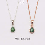 Two necklaces with green teardrop pendants on a white background, labeled 'May - Emerald'.