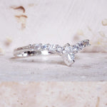 Silver ring with diamond-like stones on a light background