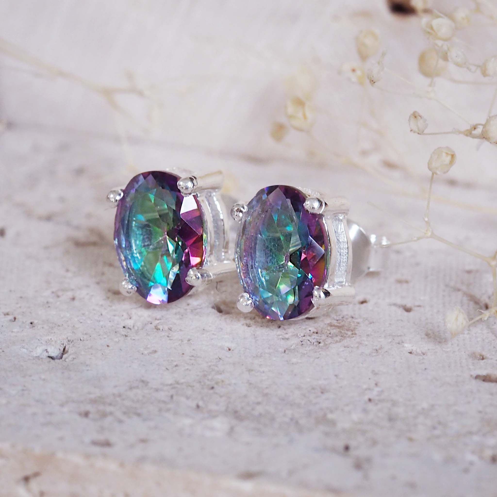 Multicolored gemstone earrings on a light background