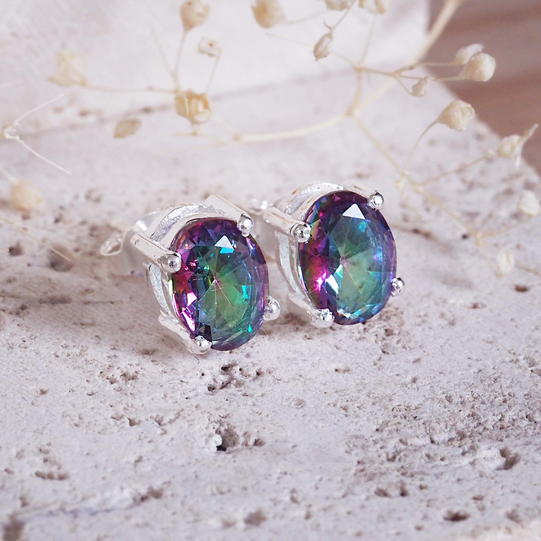 Multicolored gemstone earrings on a light background