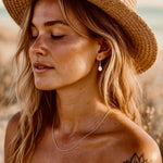 indie and harper sterling silver pink opal drop earrings being worn by a Boho chic woman 