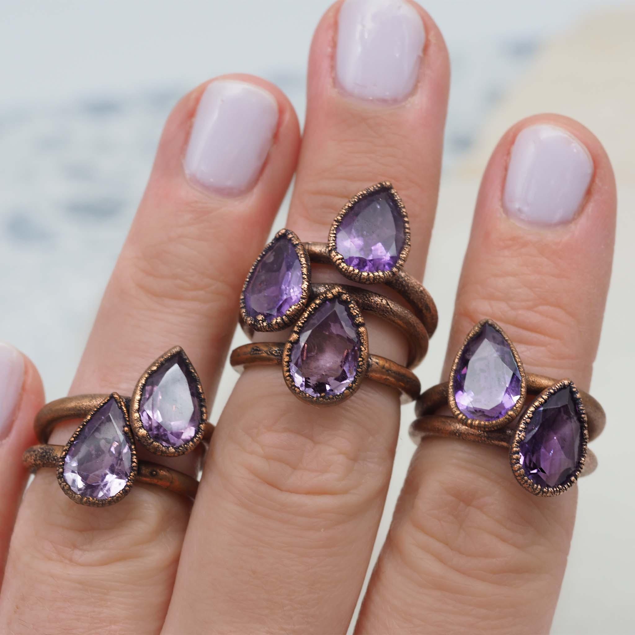 womans hand wearing multiple recycled copper and amethyst rings - womens boho jewellery by indie and Harper australia 