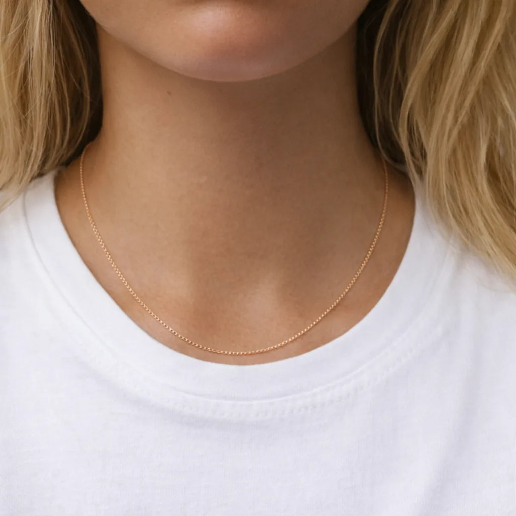 rose Gold necklace on a person wearing a white shirt