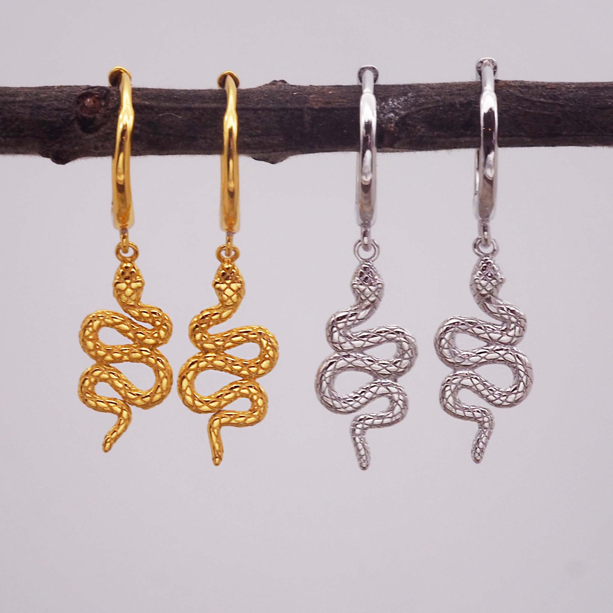 indie and harper serpent charm hoop earrings in silver and gold