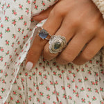 woman's hand wearing silver Labradorite rings by indie and harper australia