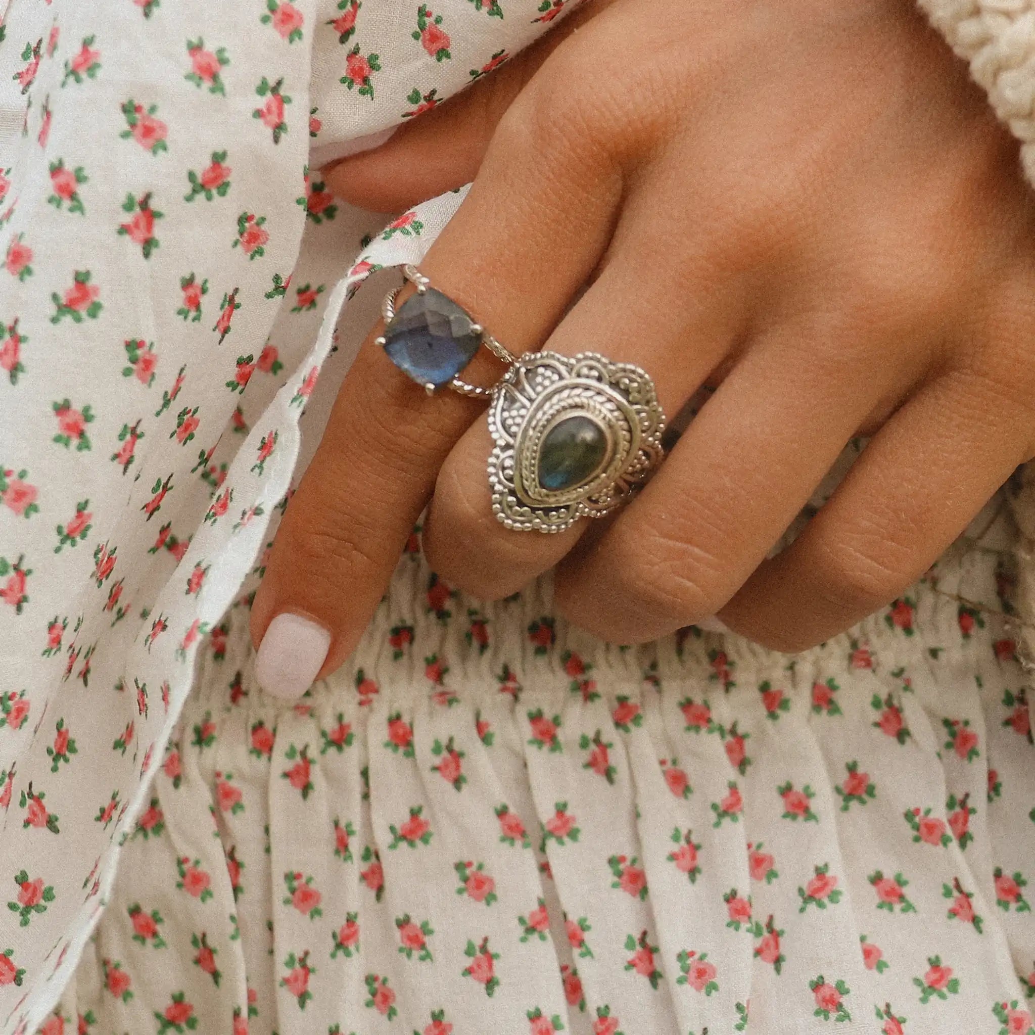 woman's hand wearing silver Labradorite rings by indie and harper australia