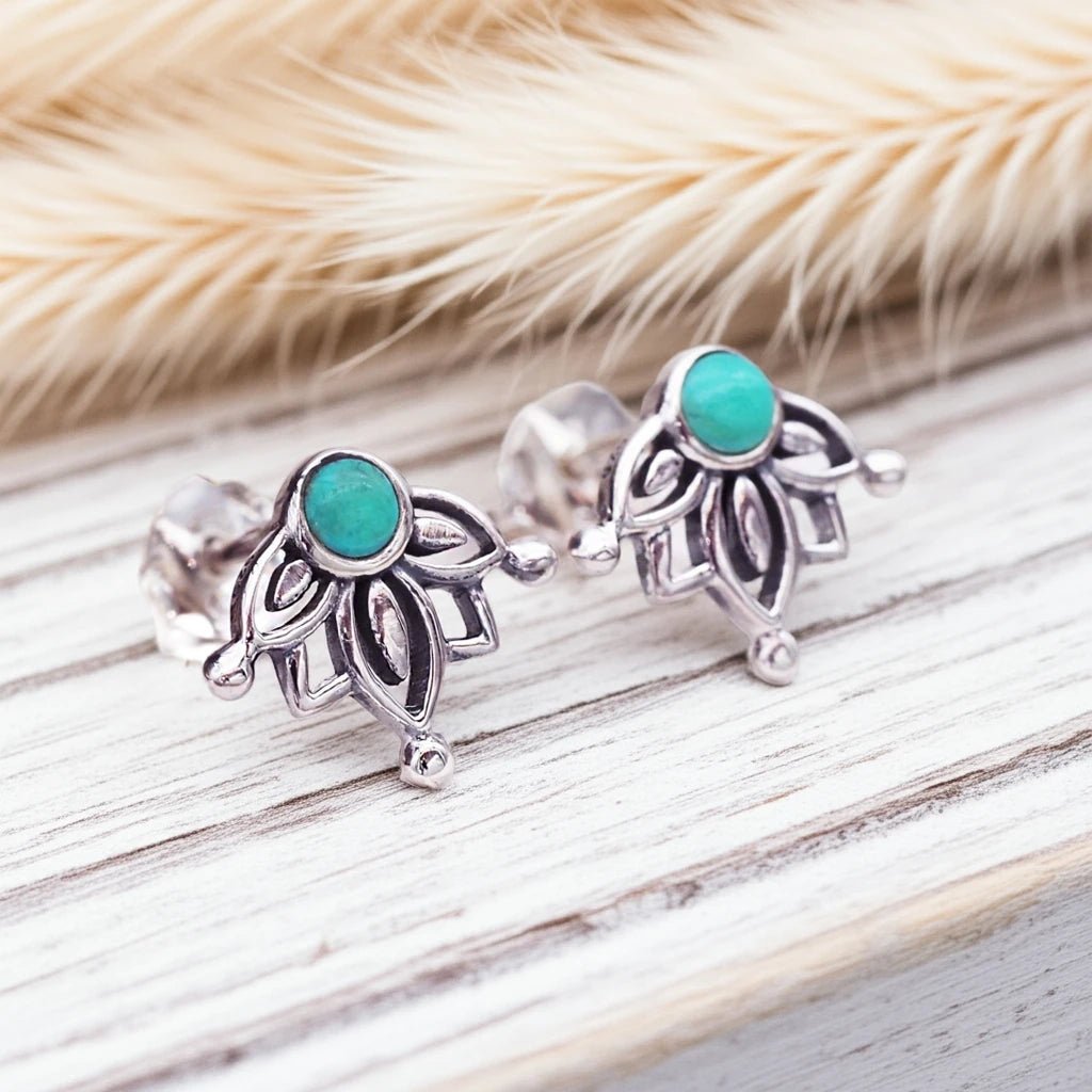 dainty sterling Silver stud earrings with turquoise stones on a wooden surface