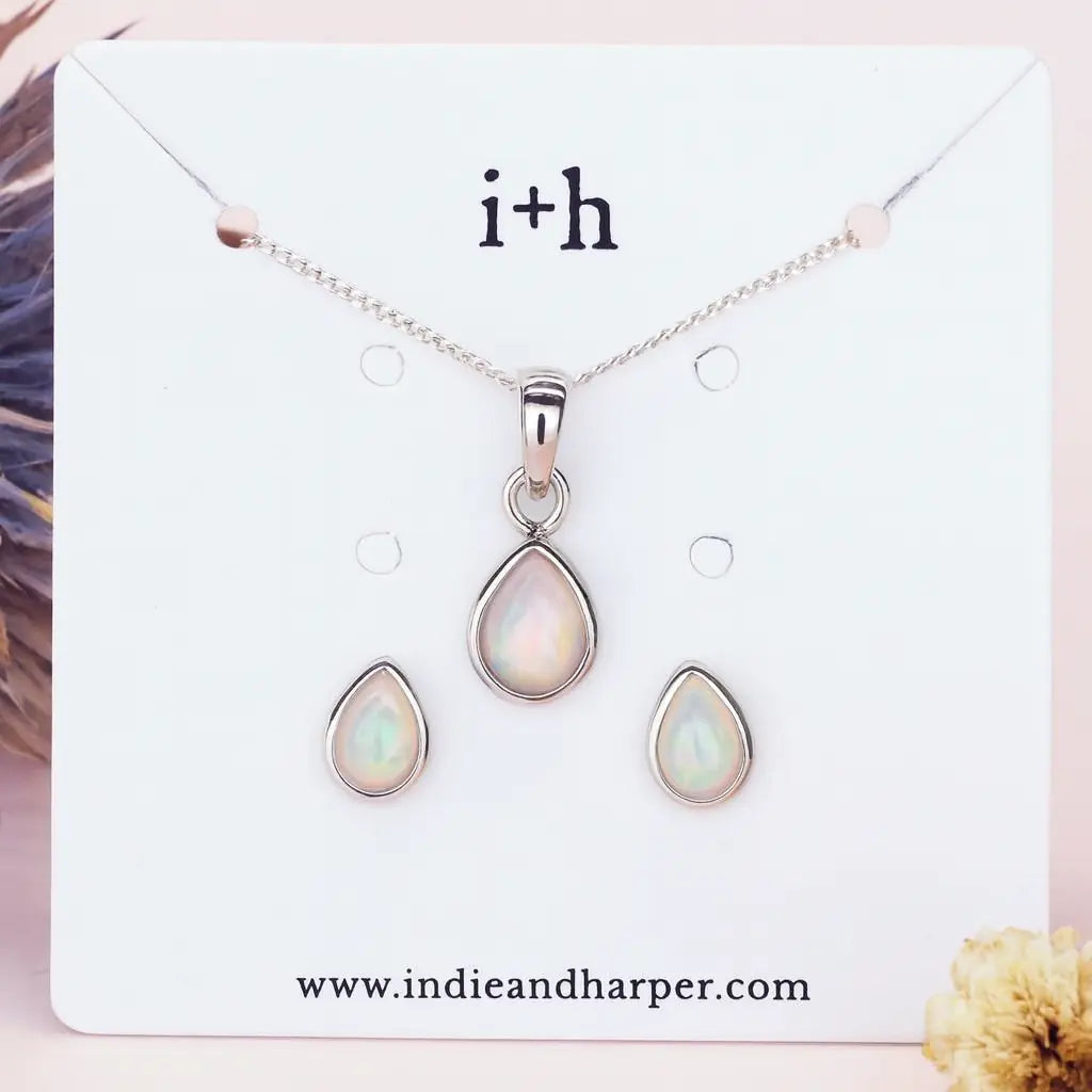 october birthstone opal Jewelry set with teardrop-shaped pendants on a display card with 'i+h' branding.
