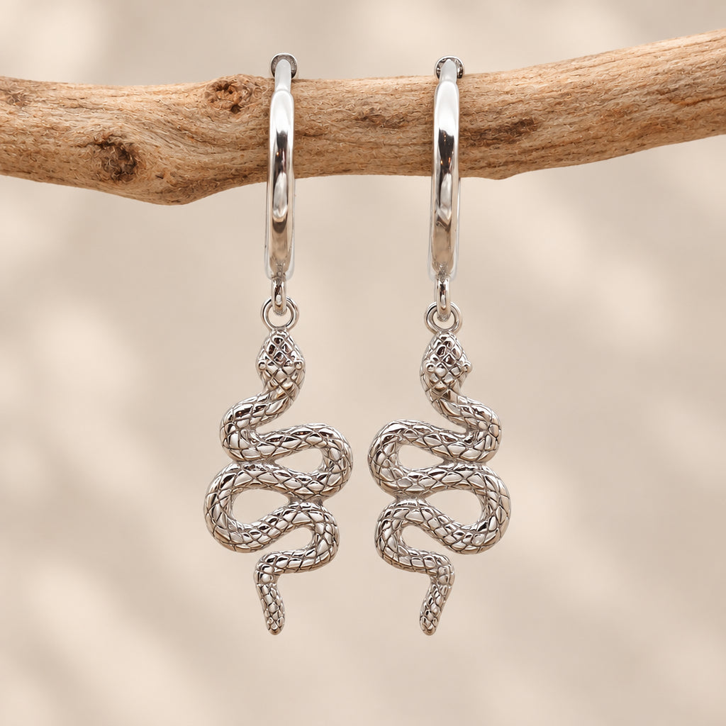 Silver serpent huggie hoop earrings with a snake charm