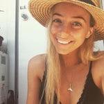 blonde woman wearing straw hat and silver whale tail necklace by indie and Harper 