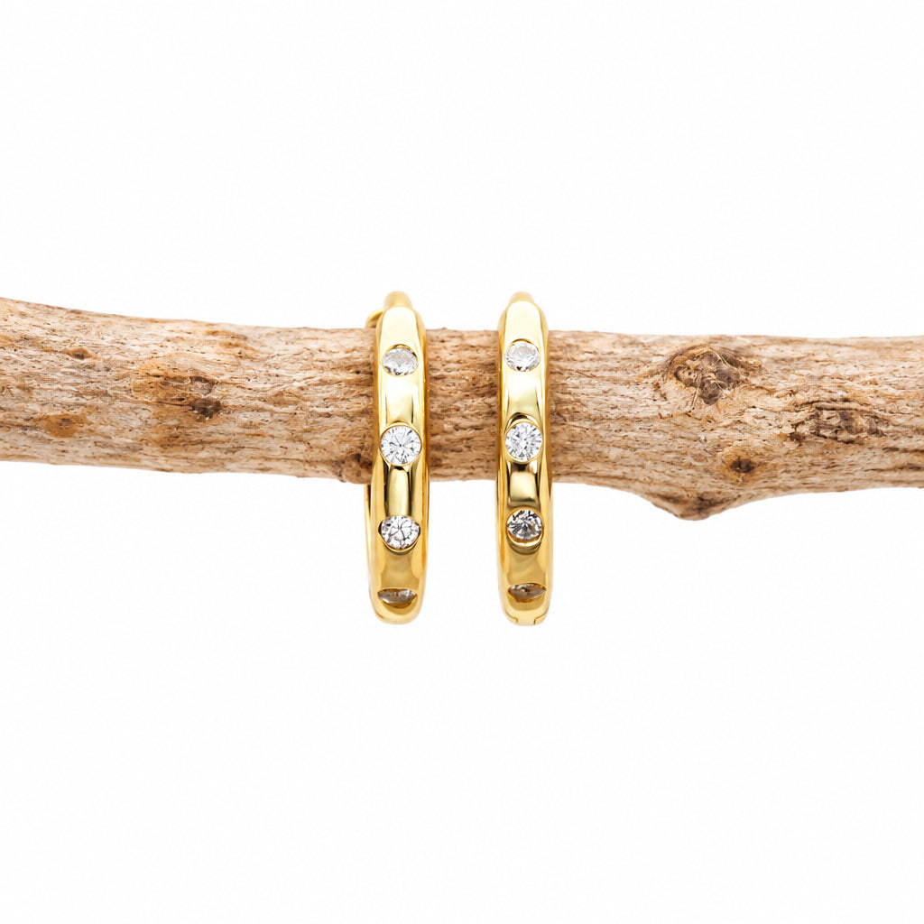 Gold CZ stacking hoop earring with small cubic zirconia, close-up