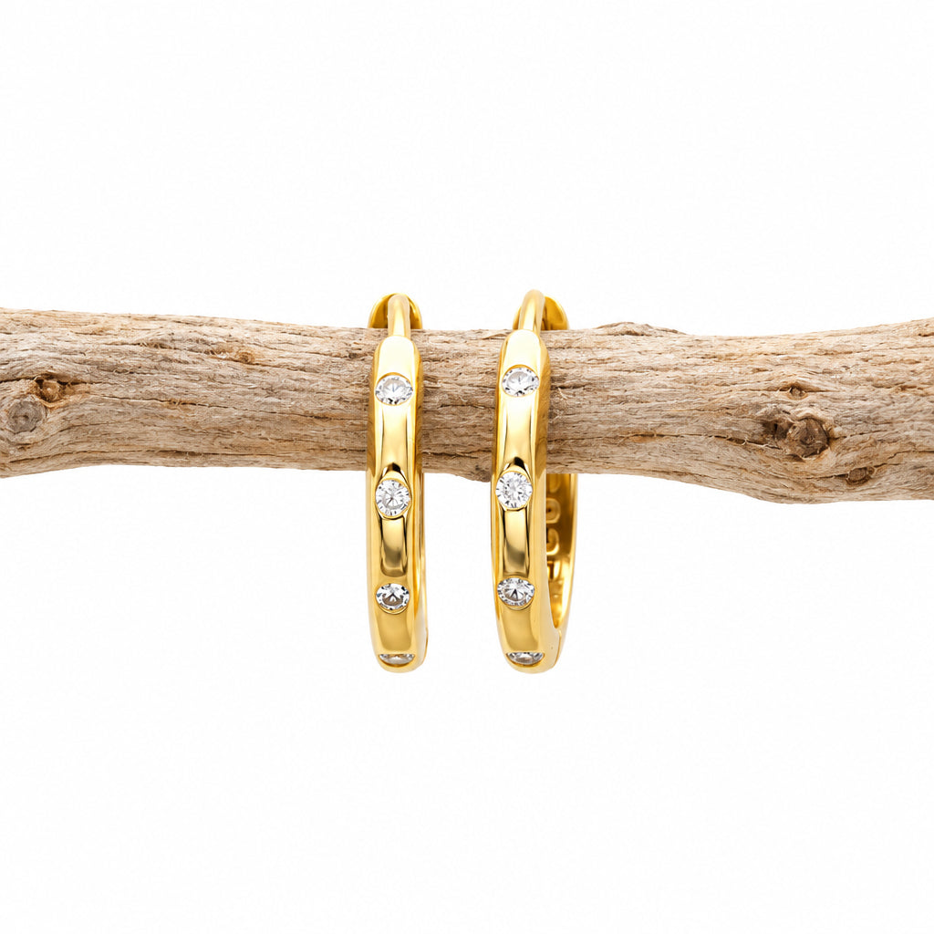 Gold CZ stacking hoop earring on a light background