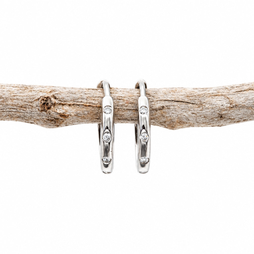 Silver CZ stacking hoop earring on a light background