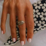 woman's hand wearing a sterling silver navajo carved feather ring - indie and harper
