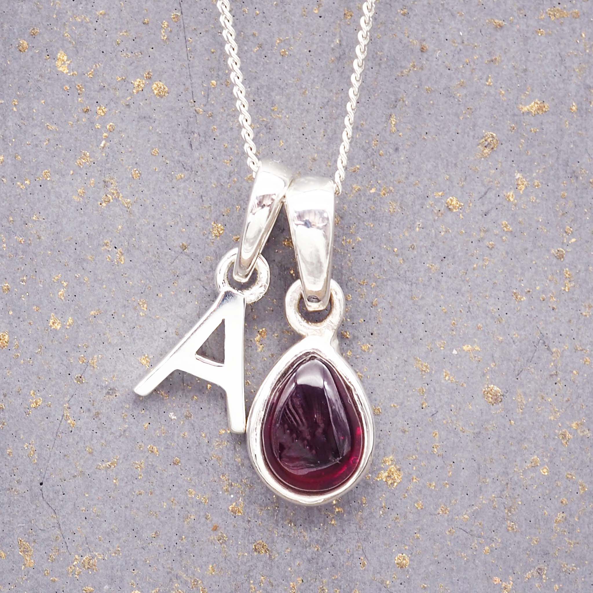 indie and harper sterling silver initial pendant and january birthstone garnet necklace