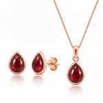Rose Gold january birthstone jewellery set featuring a teardrop-shaped red natural garnet gemstone pendant necklace, matching stud garnet earrings on a clean white background.