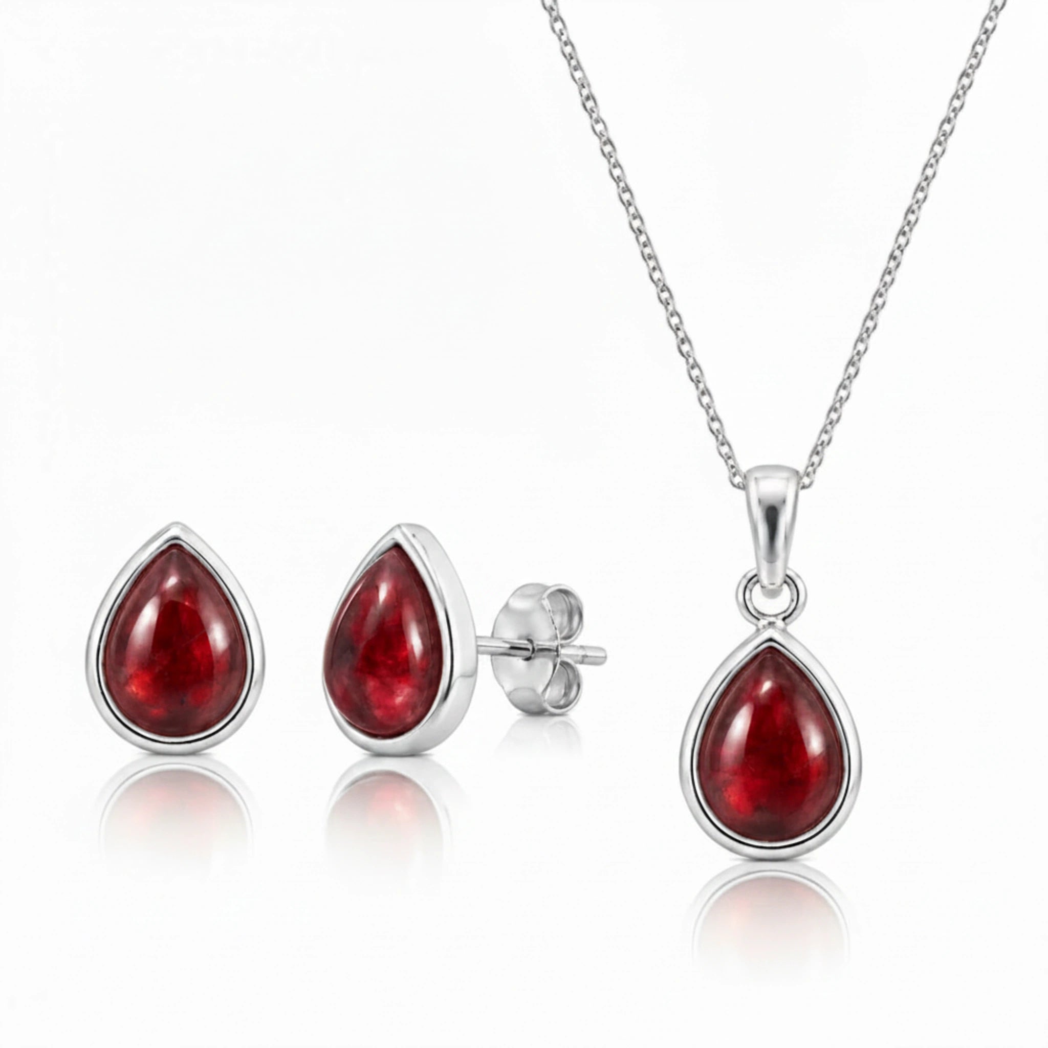 Sterling Silver Garnet jewellery set featuring a teardrop-shaped natural red garnet gemstone pendant necklace, matching stud garnet earrings on a clean white background.