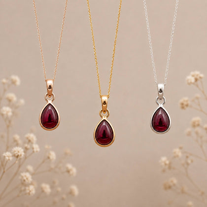 three january birthstone garnet necklaces hanging with teardrop natural garnet gemstones in rose gold, gold and sterling silver