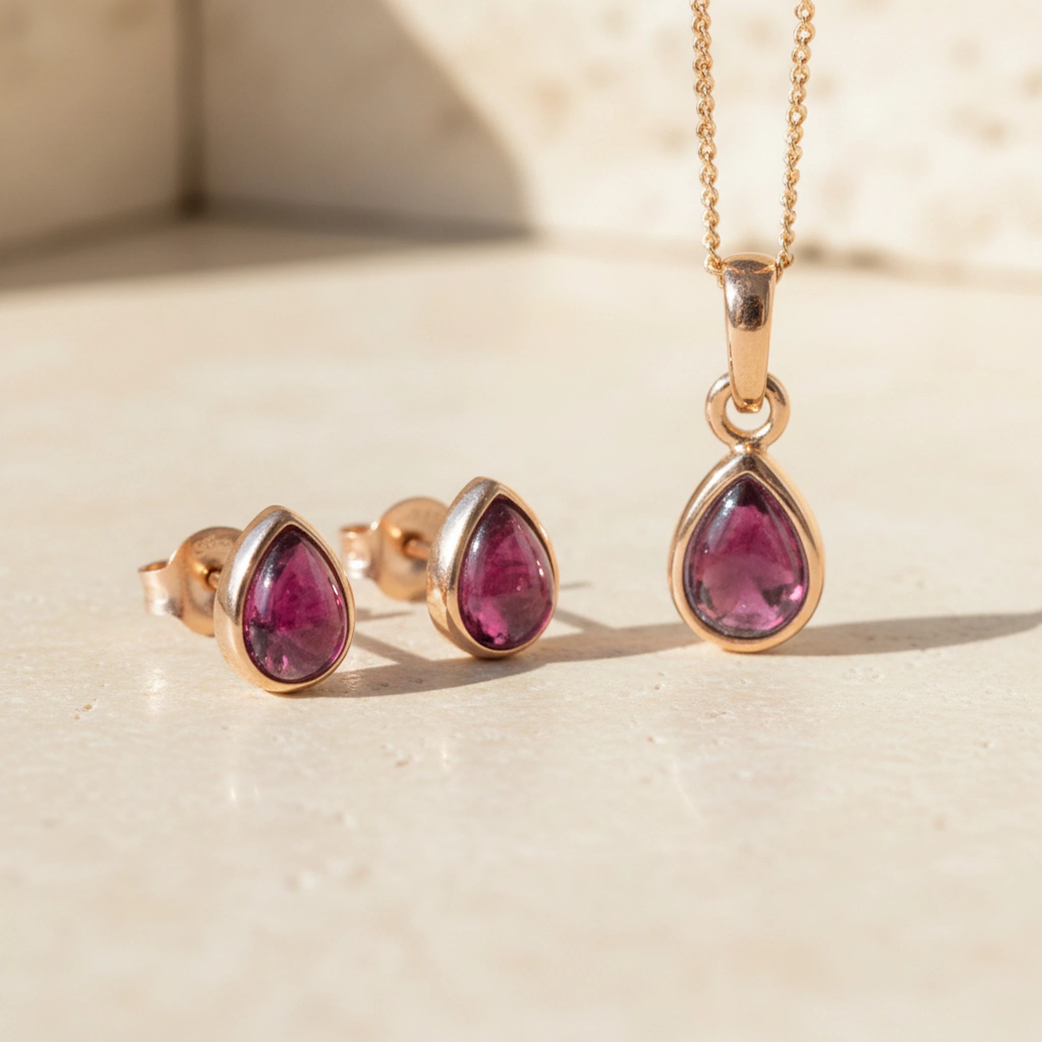 Rose Gold January Birthstone Garnet Jewellery Set including pear-shaped Garnet stud earrings and pendant necklace