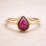 Gold July birthstone Ring with pear-shaped natural ruby gemstone as a meaningful birthday jewellery gift for her.
