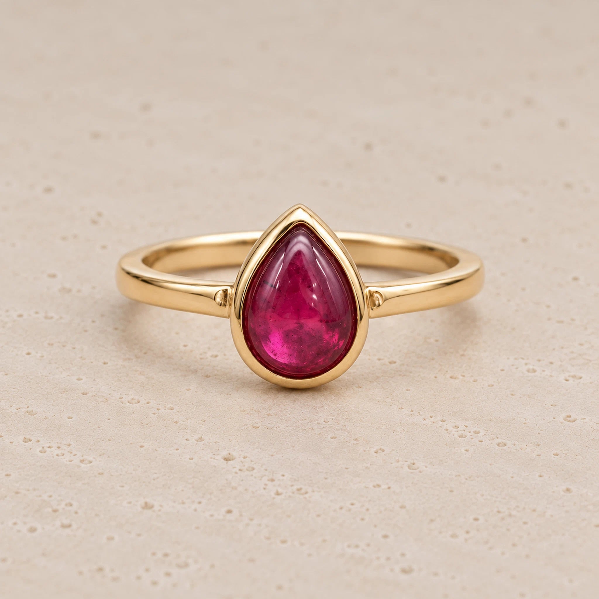 Gold July birthstone Ring with pear-shaped natural ruby gemstone as a meaningful birthday jewellery gift for her.