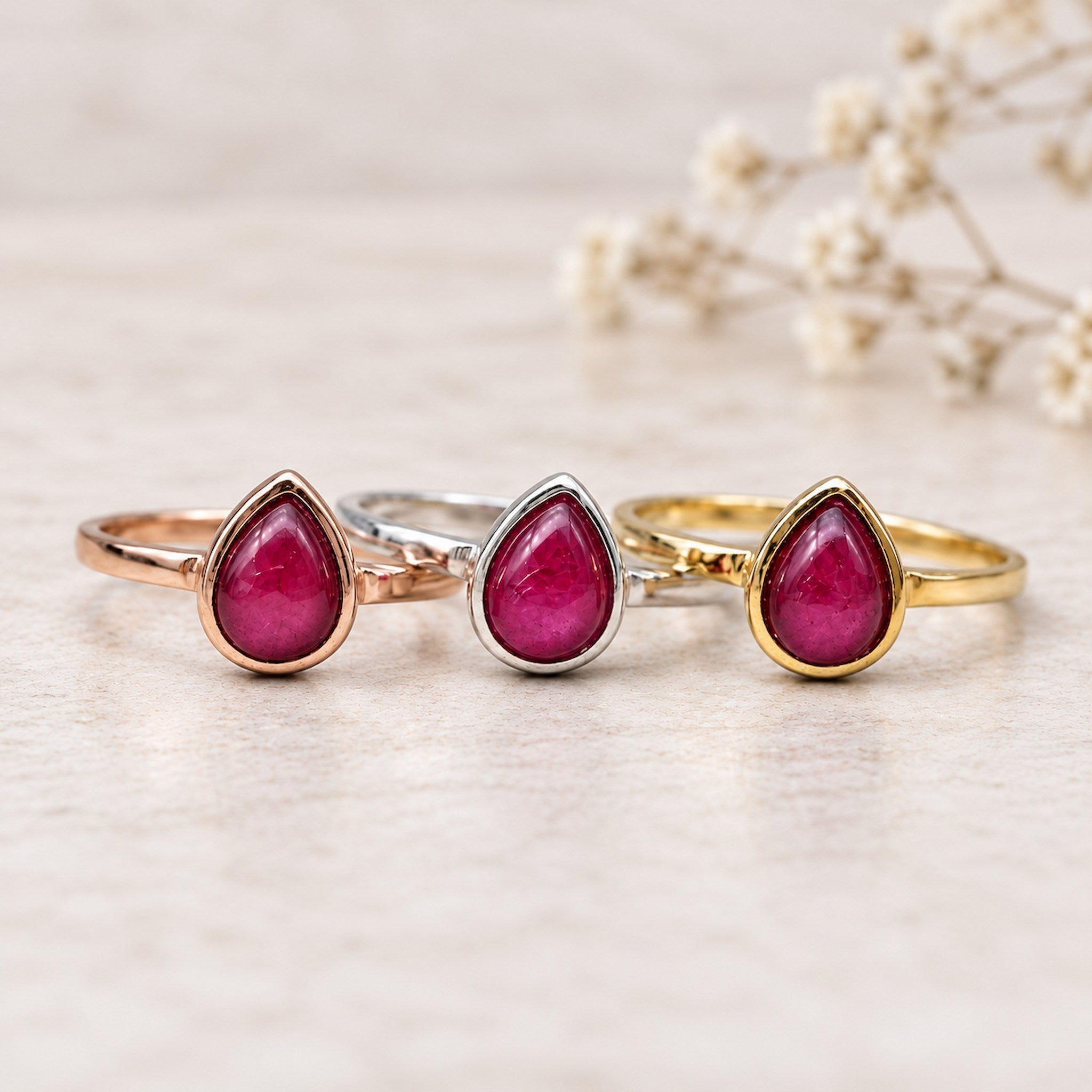 July birthstone Rings with pear-shaped natural ruby gemstones as meaningful birthday jewellery gifts for her.