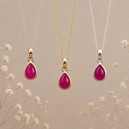 July Birthstone Ruby Necklace set of 3 with teardrop ruby pendants in rose gold, yellow gold, and silver.