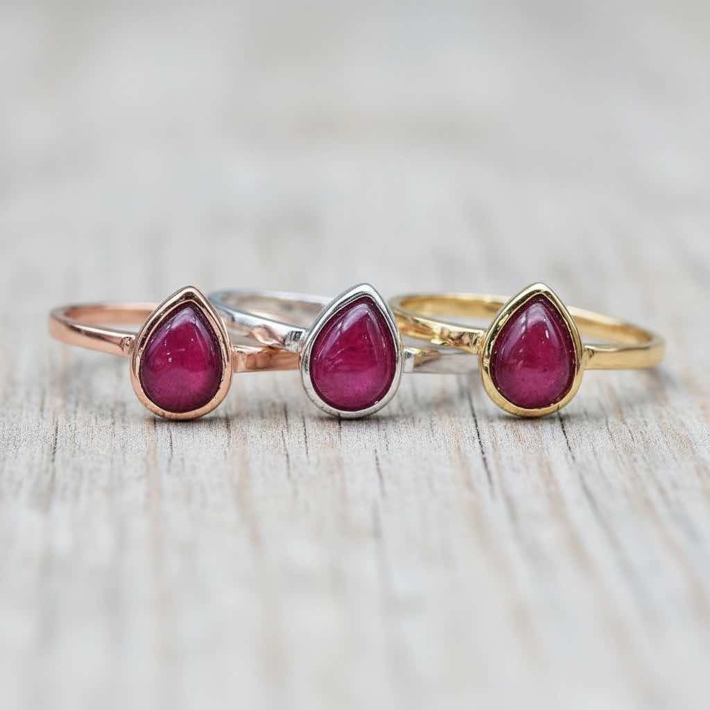 July Birthstone ruby Rings in rose gold, silver and gold on a wooden surface