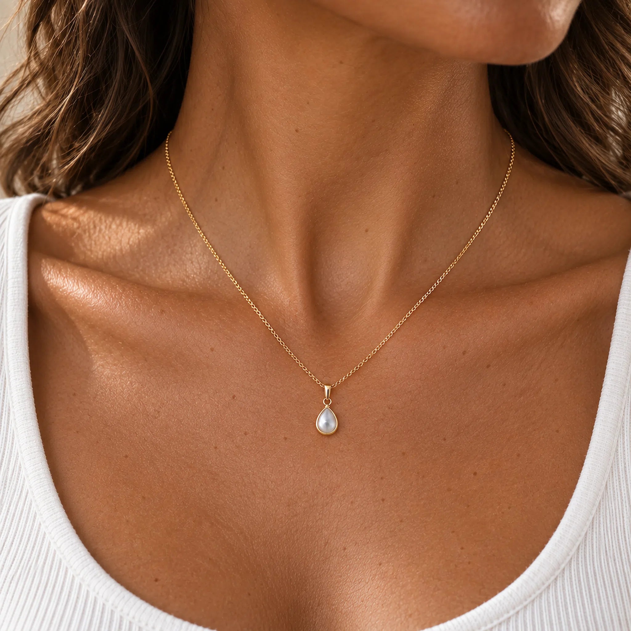 Gold June birthstone necklace with pear-shaped mother of pearl pendant worn - june birthday jewellery gift for her