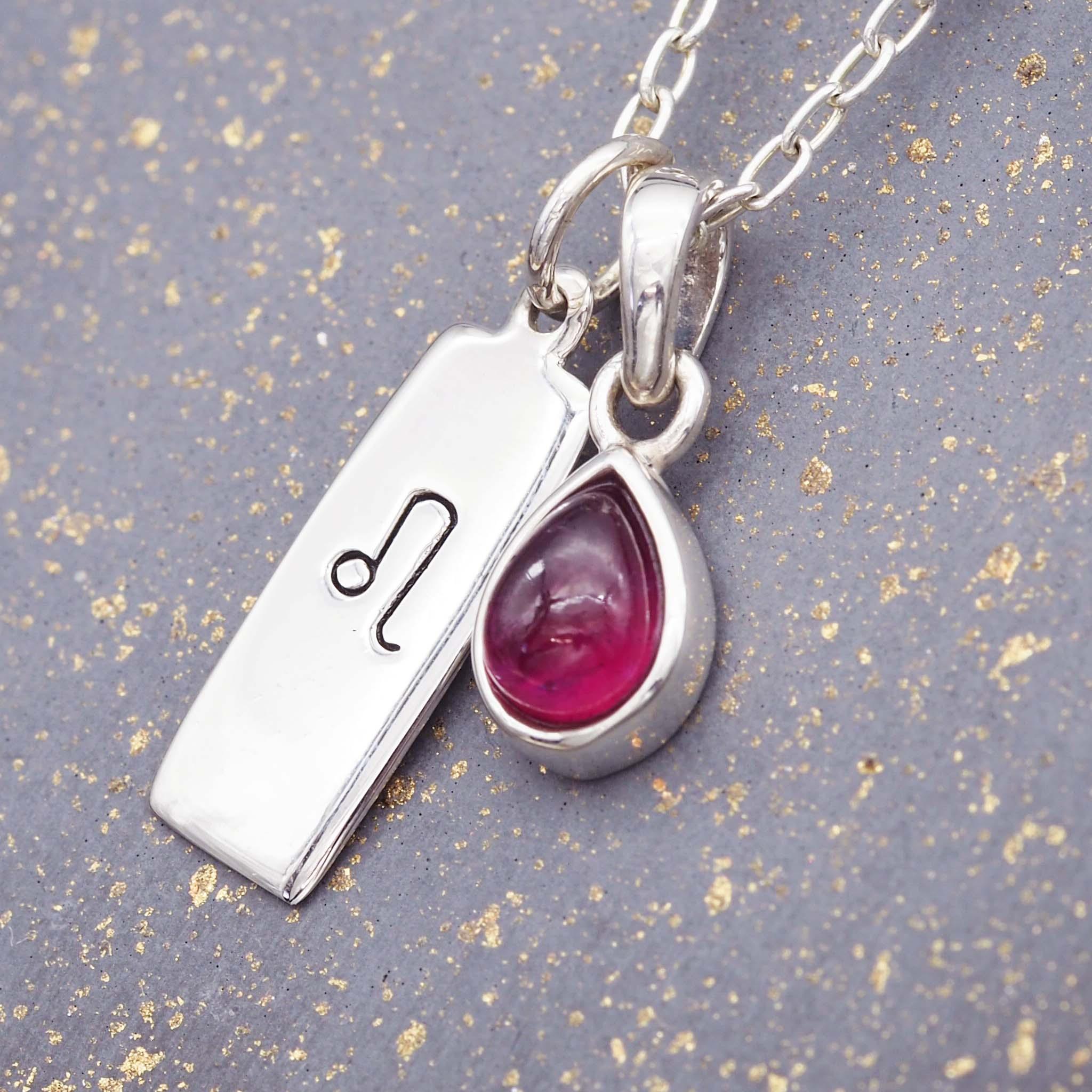 Sterling silver Leo star sign necklace with a deep red genuine ruby July birthstone charm by indie and harper