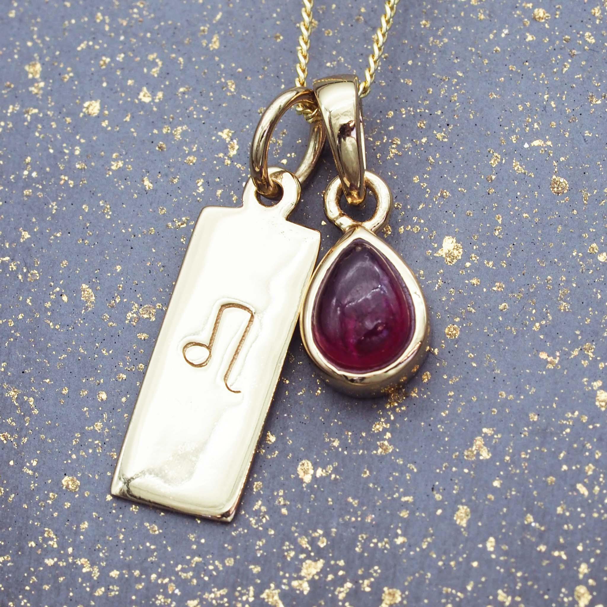 gold star sign necklace with a deep red genuine ruby July birthstone charm by indie and harper