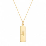 A gold leo necklace featuring a rectangular pendant necklace engraved with the Leo zodiac symbol, suspended from a delicate gold chain against a solid white background.