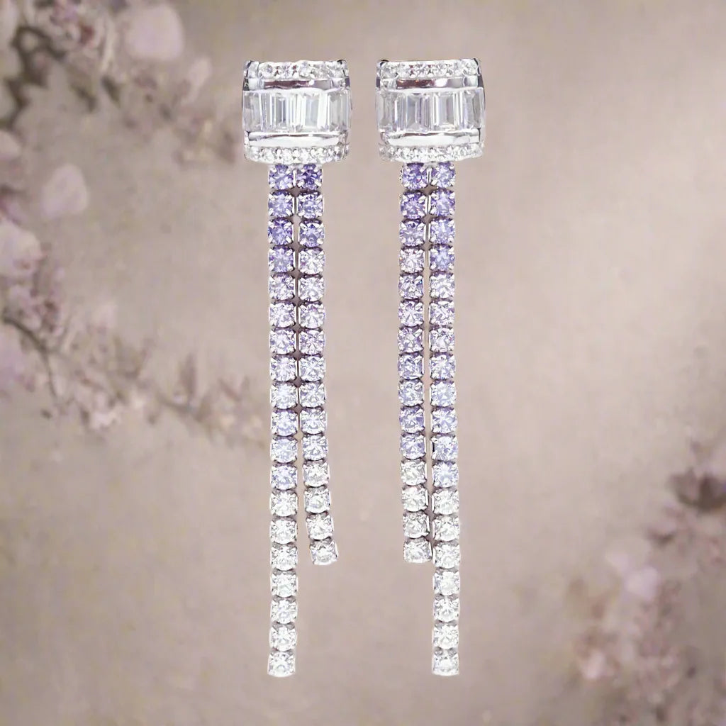 Pair of diamond earrings on a neutral background