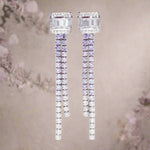 Pair of diamond earrings on a neutral background