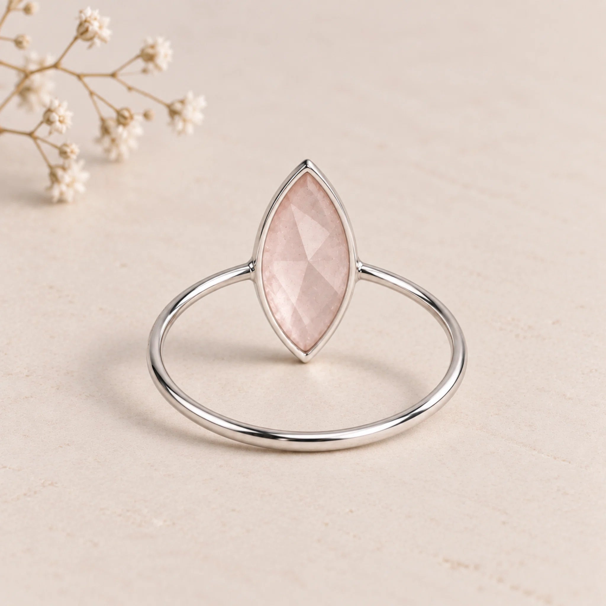 back of a sterling silver rose cut, bezel set, marquise shaped natural rose quartz ring