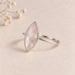 side image of a sterling silver rose cut, bezel set, marquise shaped natural rose quartz ring