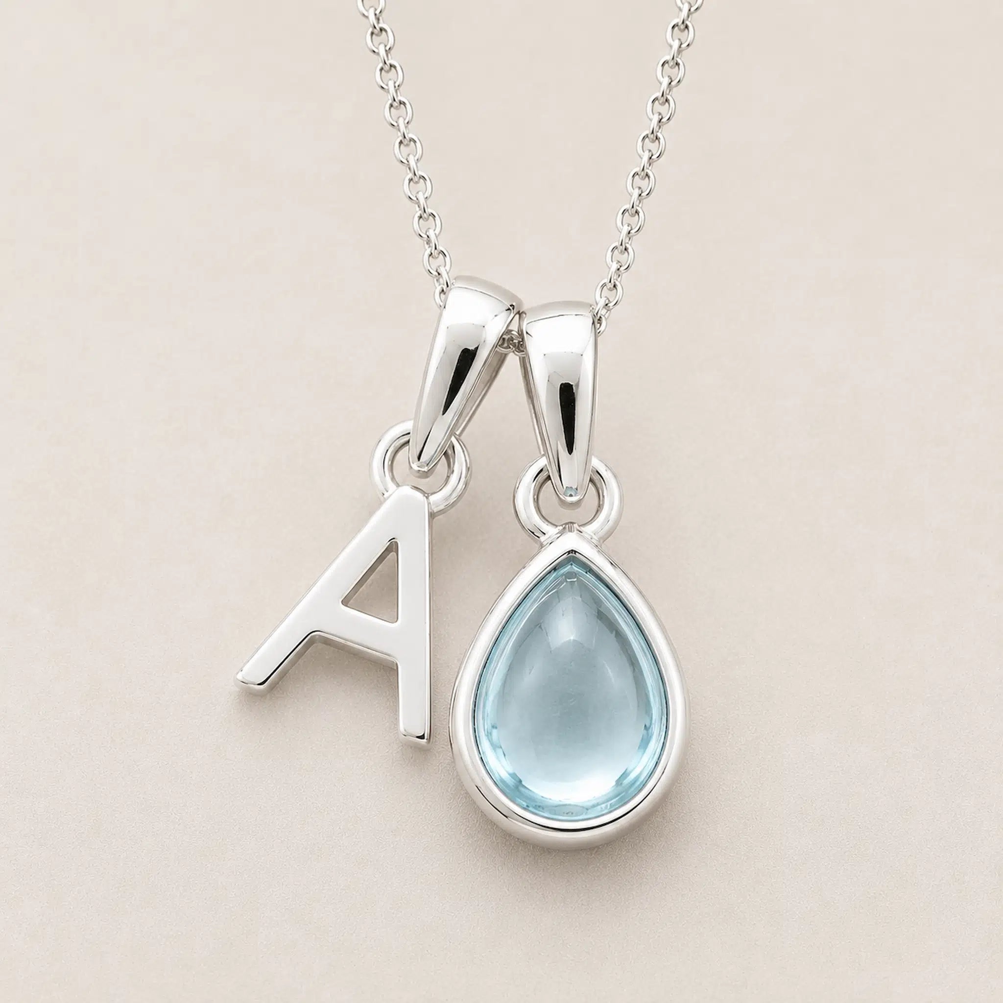 Sterling Silver March birthstone Necklace with a pear-shaped natural Aquamarine gemstone pendant and letter 'A' charm