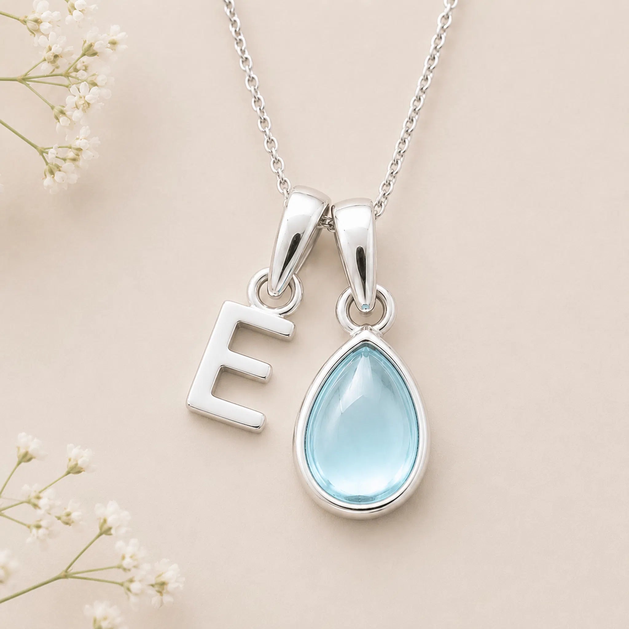 Sterling Silver March birthstone Necklace with a pear-shaped natural Aquamarine gemstone pendant and letter 'E' charm