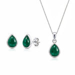 Sterling Silver May Birthstone Jewellery set featuring a pair of teardrop stud natural emerald earrings and matching natural emerald pendant necklace on a white background