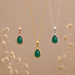 three may birthstone emerald necklaces in rose gold, gold and silver with dainty teardrop cabochon bezel set natural emeralds