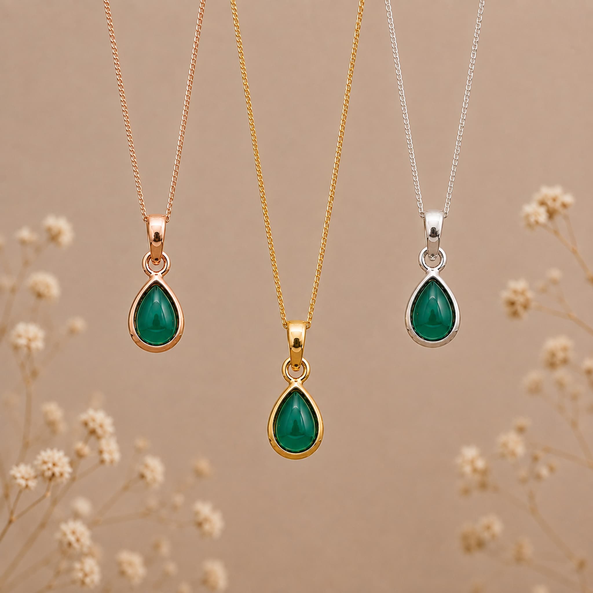 three may birthstone emerald necklaces in rose gold, gold and silver with dainty teardrop cabochon bezel set natural emeralds