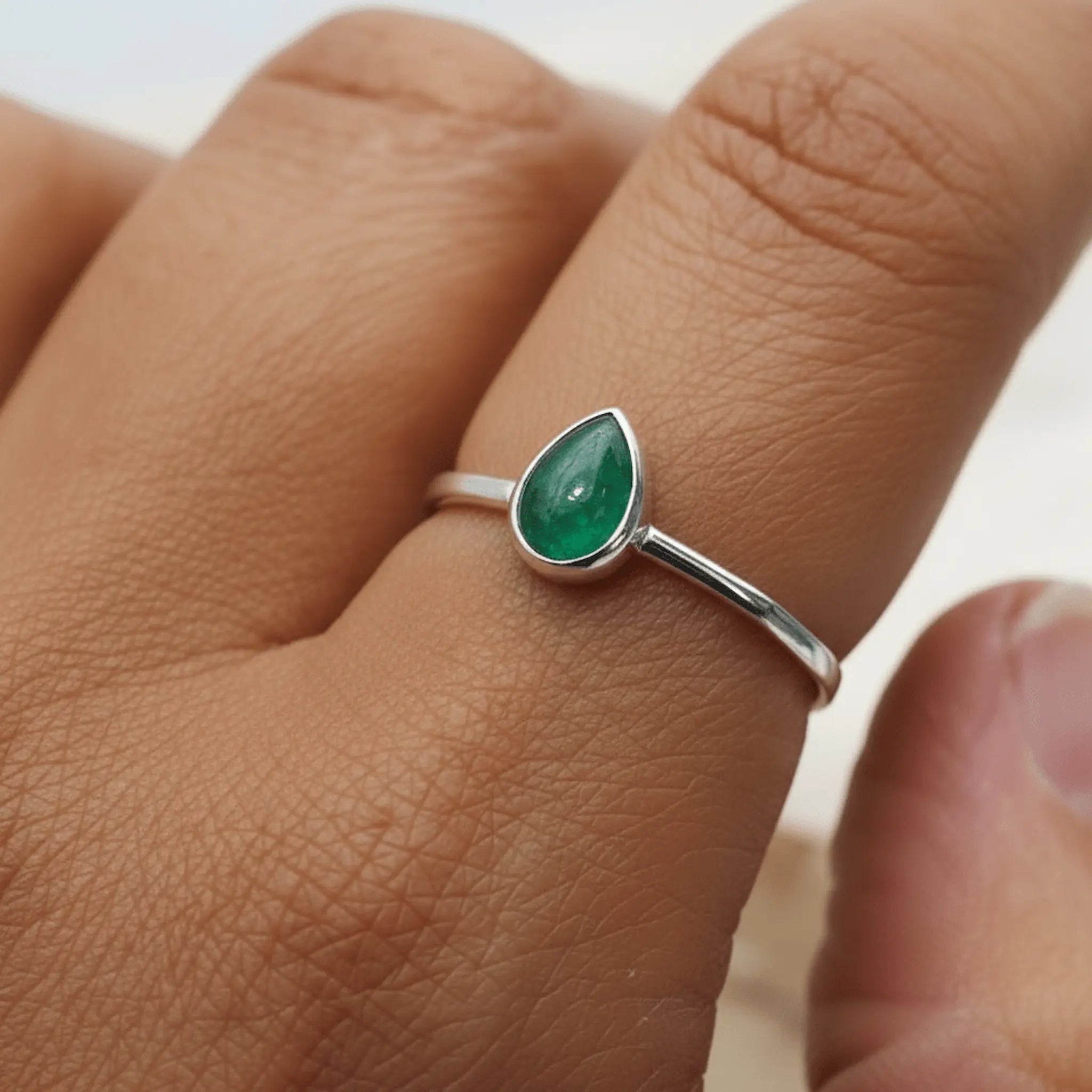Sterling Silver may birthstone ring with natural emerald gemstone worn as a meaningful may birthstone jewellery gift for her