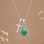 sterling silver initial t may birthstone natural emerald pendant necklace against a dark warm beige background