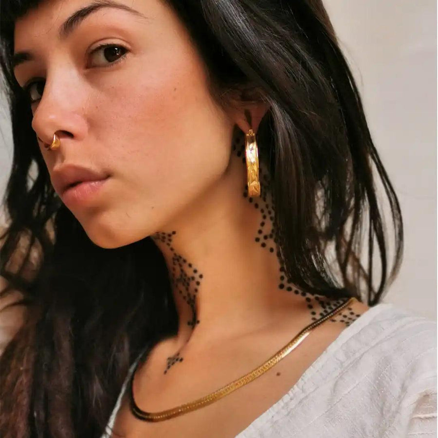 Boho Woman with dreadlocks wearing gold jewellery- gold waterproof jewellery - Australian jewellery brand