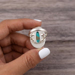 fingers holding a Sterling Silver Boho Ring with mohave turquoise gemstone showing the back of the open ring