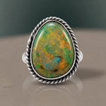 Monarch Opal Ring with a green opal and orange flashes of colour in a twisted rope bezel, close-up