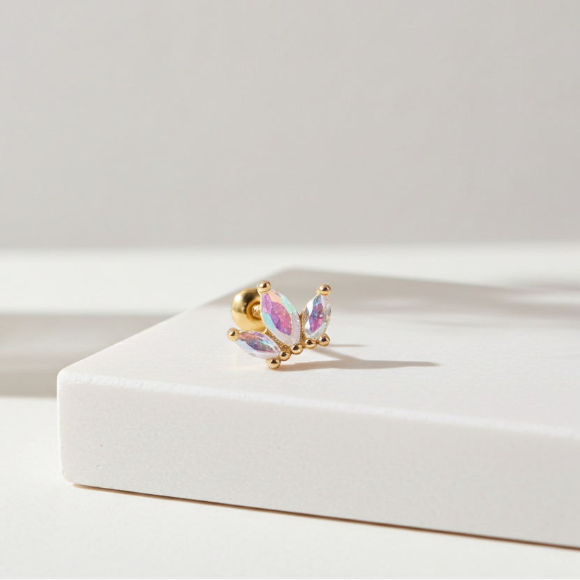 Butterfly-shaped earring on a white surface with a soft focus background