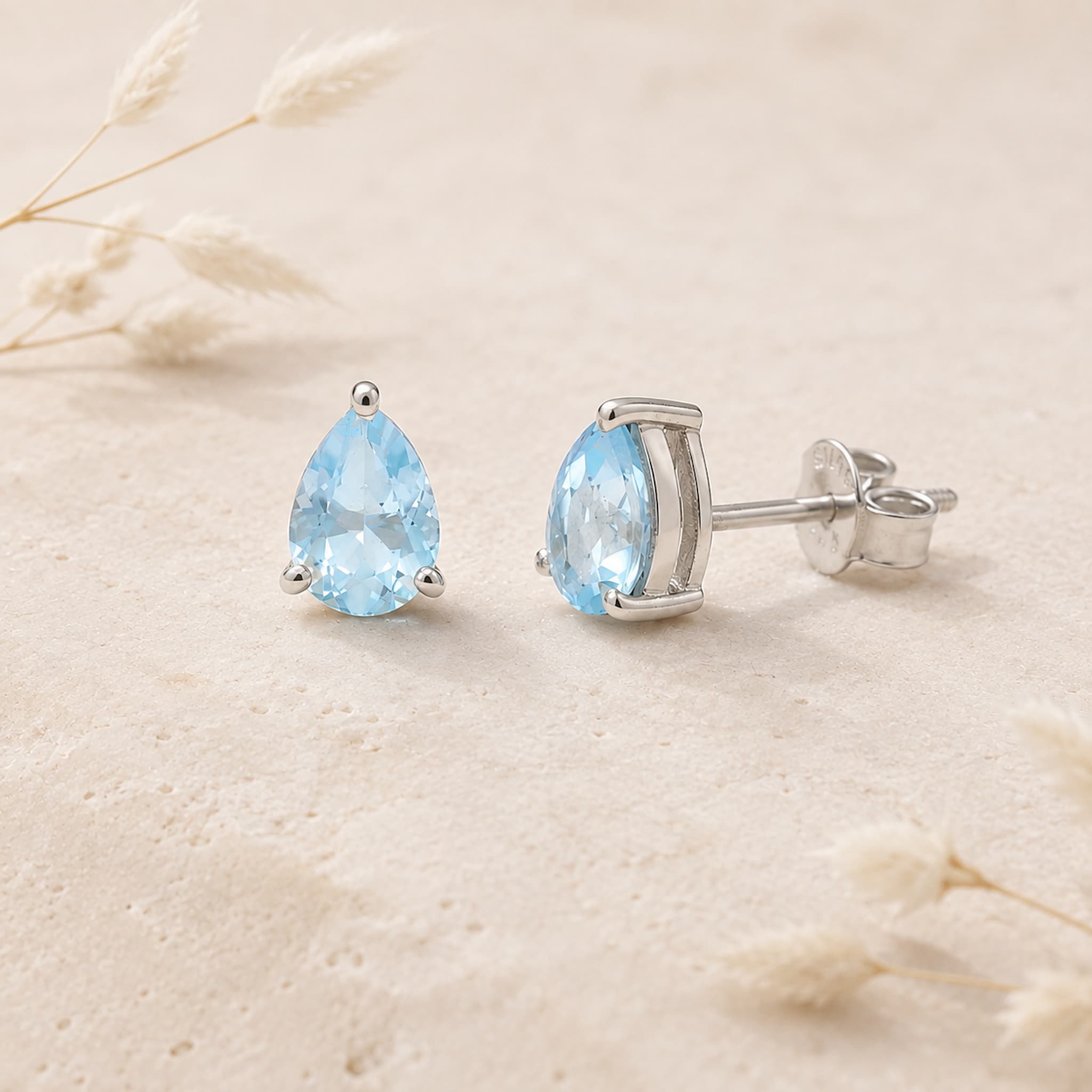 sterling silver facted claw-set pear-shaped natural blue topaz stud earrings