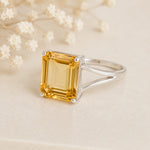 Sterling Silver Statement Style Ring wtih large emerald-cut claw set natural citrine on a light background